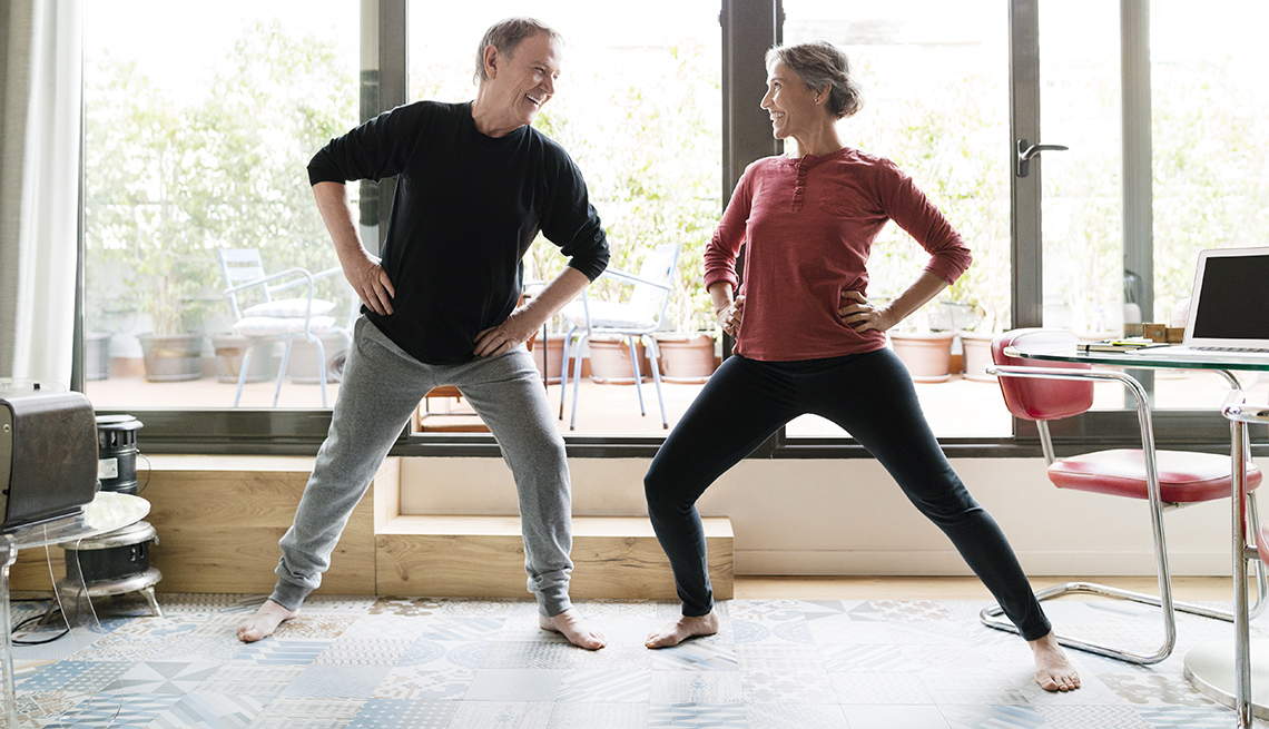 Man and woman taking an exercise break in a home office
