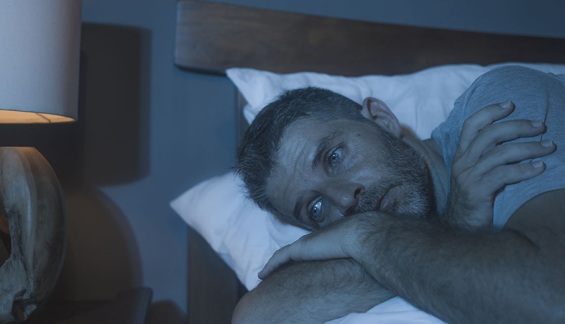 depressed older man in bed