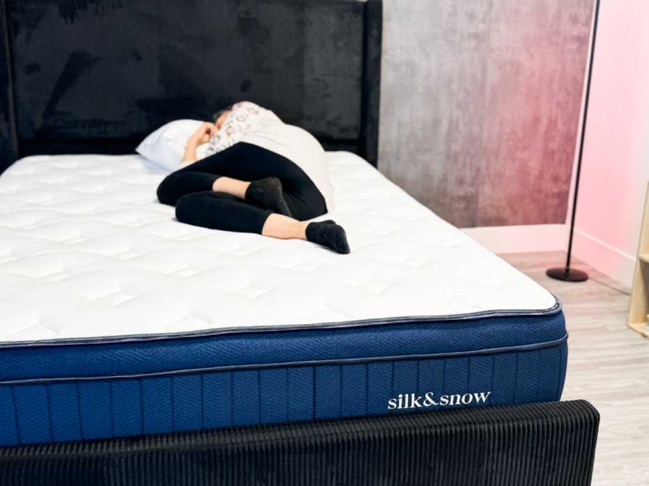 Woman on mattress lying on her side
