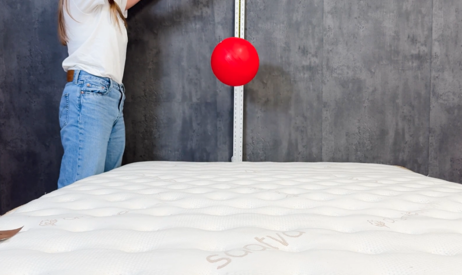 A 15-pound ball being dropped on the Saatva Classic mattress to measure the bounce.