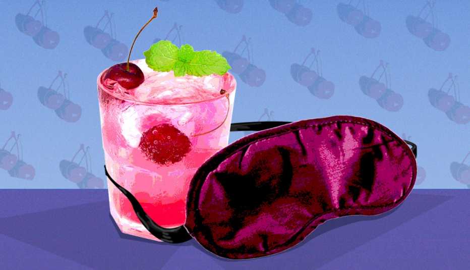Sleepy Girl Mocktail - Does it work? a glass of a cherry mocktail with a mint garnish a sleep eye mask is wrapped around the glass