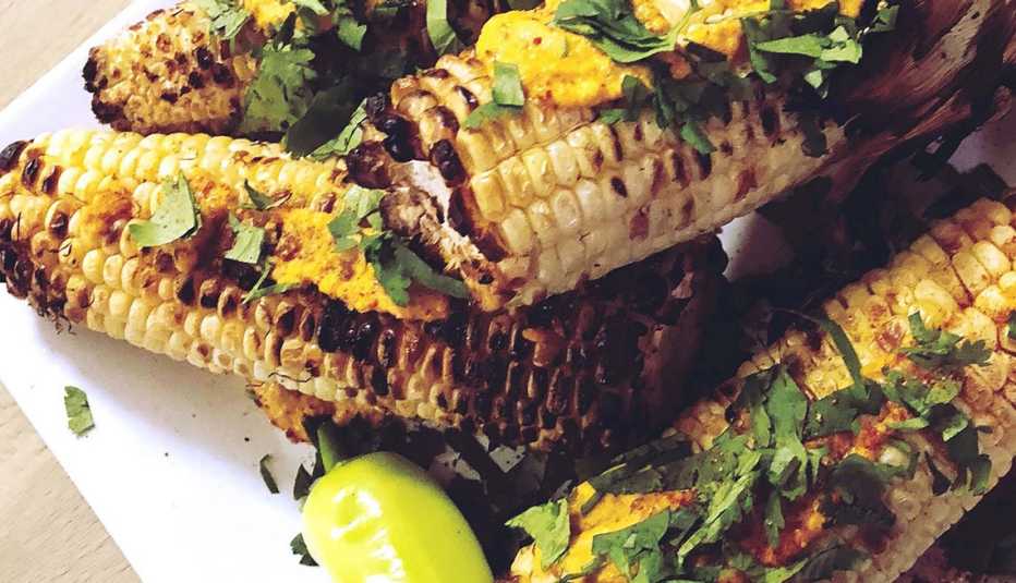 plate full of grilled corn with seasoning plate full of grilled corn with seasoning