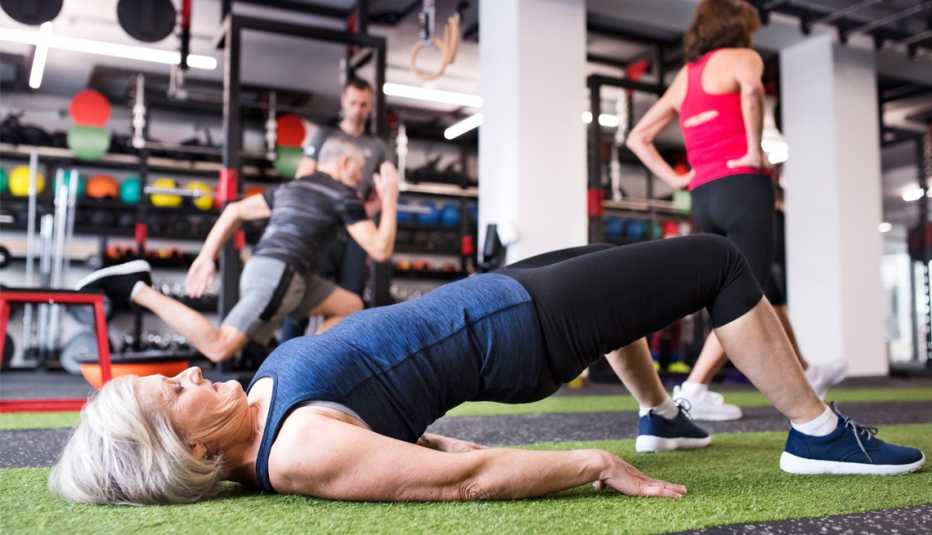 a woman at a gym doing a bridge exercise