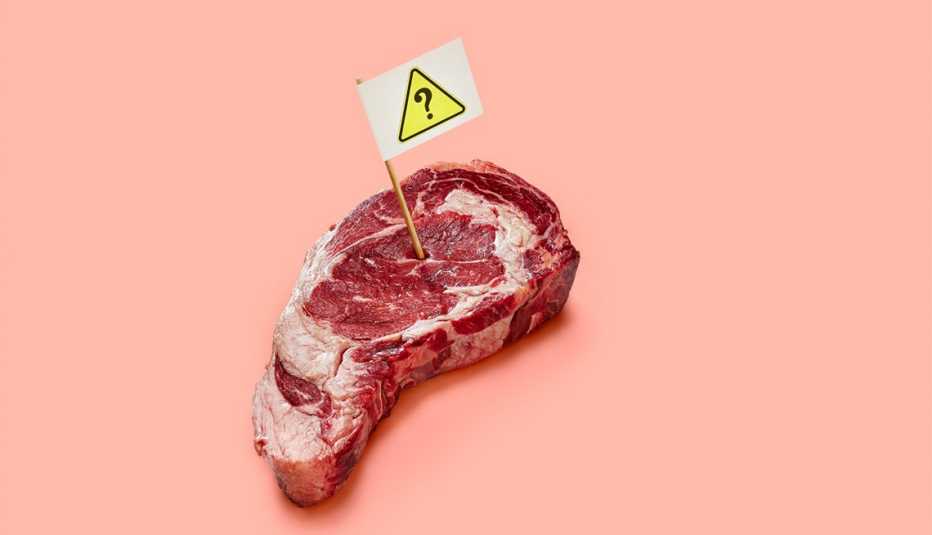 steak with toothpick with a caution sign on it stuck in it