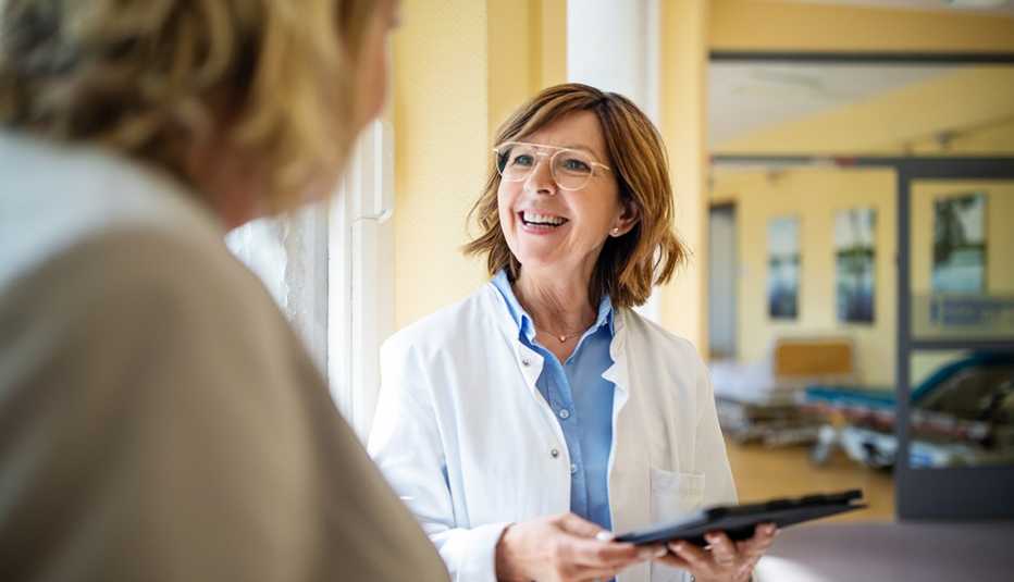 doctor holding a digital tablet and talking to a patient