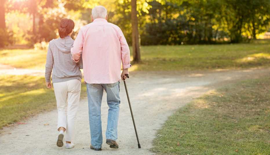 Man walking with a cane outdoors
