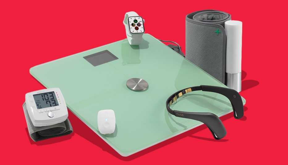 a grouping of fitness devices. clockwise from top are an apple watch, moca cuff blood pressure monitor, muse 2 headband, withings body plus scale, upright go posture trainer, and withings blood pressure  monitor