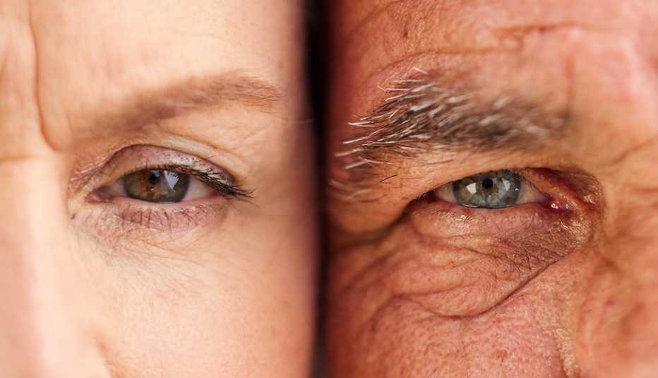 closeup of a man and woman with heads together focused on their eyes closeup of a man and woman with heads together focused on their eyes