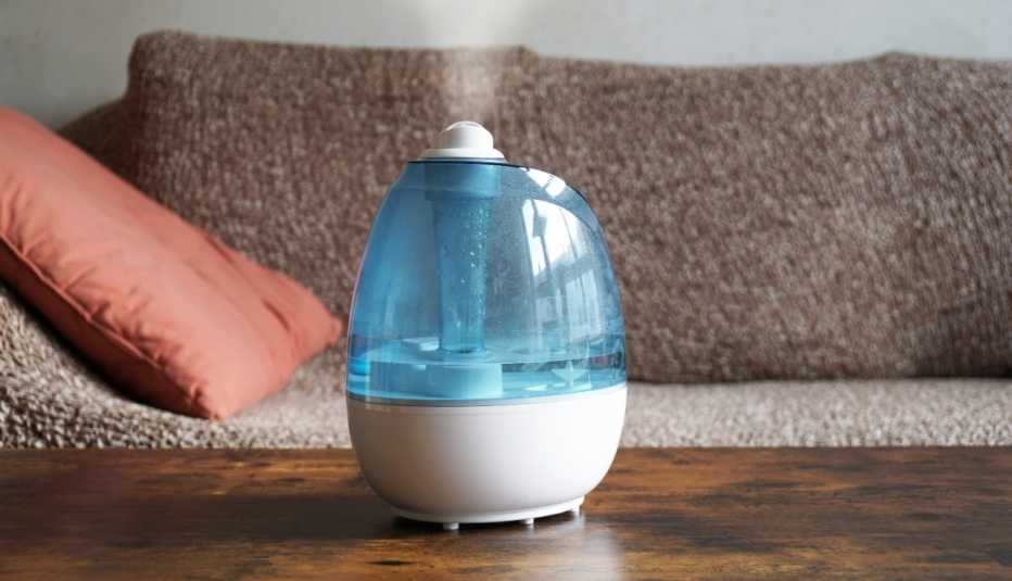A dehumidifier on a coffee table helps improve air circulation in the living room