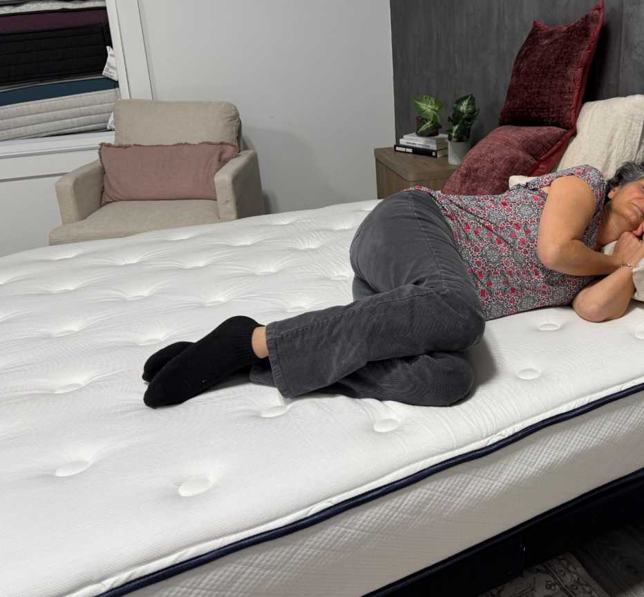 A woman lying on her side on the WinkBeds GravityLux
