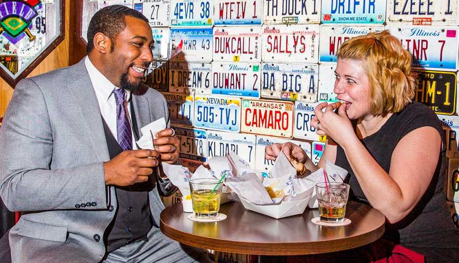 A man and woman eating at a restaurant. A man and woman eating at a restaurant.