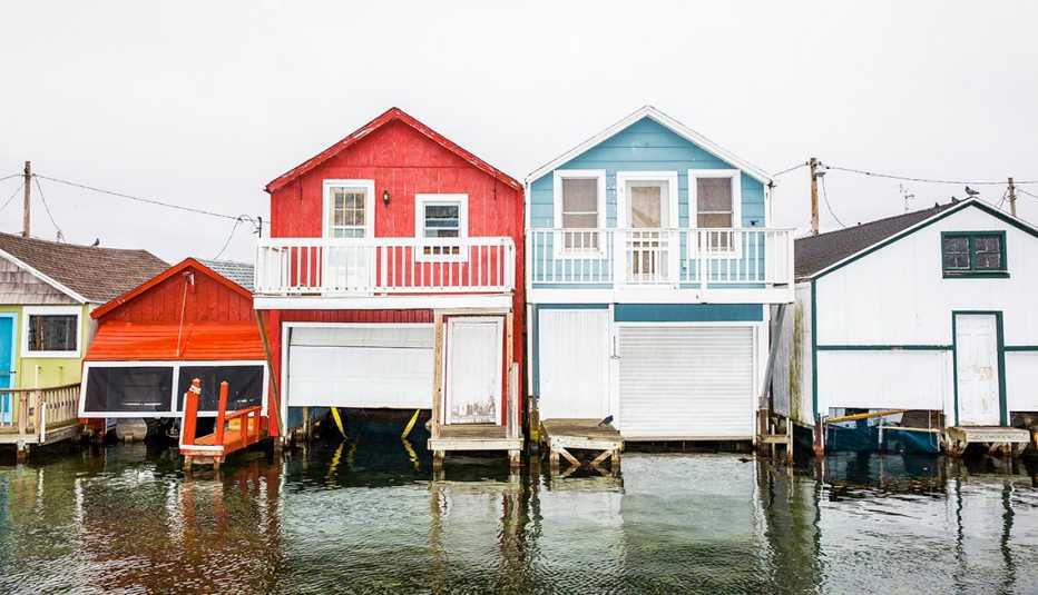 Colorful elevated homes with water rising below. Colorful elevated homes with water rising below.