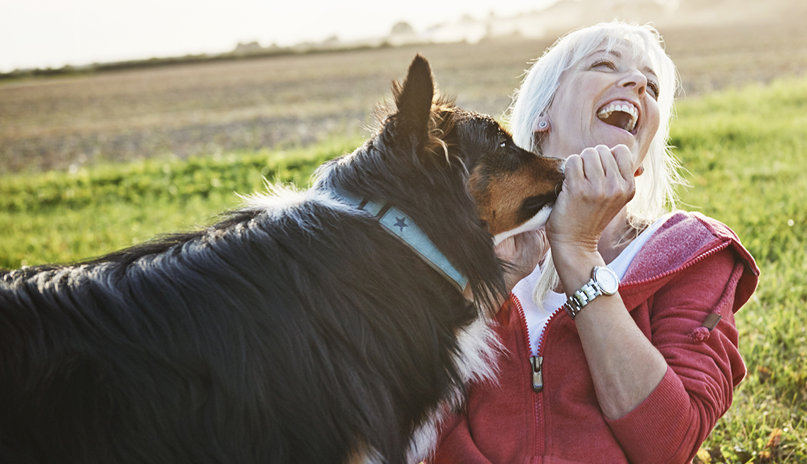 a woman and a dog in a field