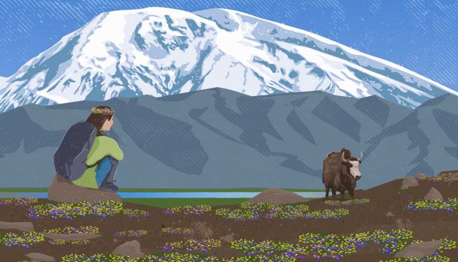 A woman wearing a backpack sits on a rock and watches a yak in the distance with Muztagata, a mountain in China, in the background. 