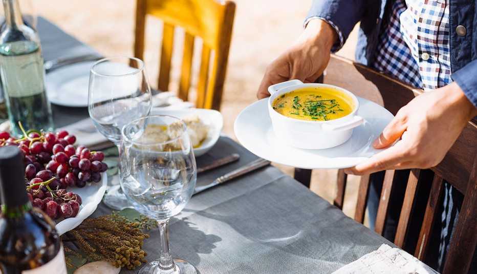 Man holding a soup dish