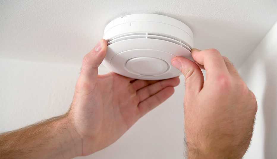 Man installing smoke detector
