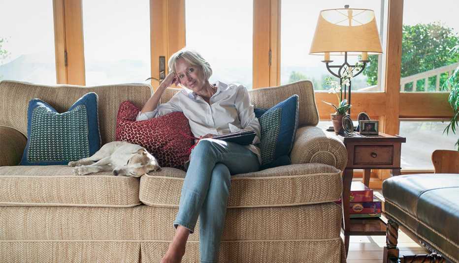 woman sitting on a couch with her dog