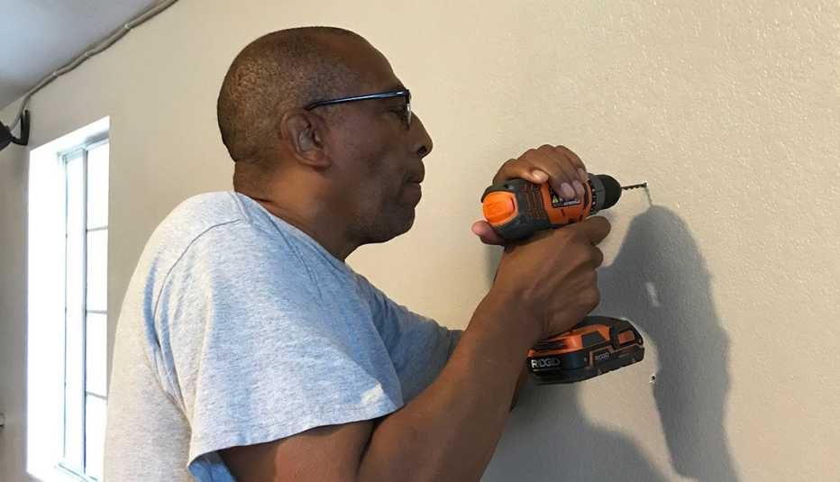 Theodis Scott with a drill 