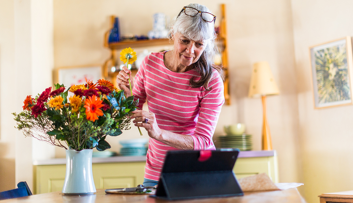 woman watching a tutorial and arranging flowers