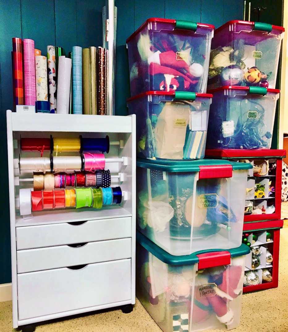a rolling cart stores long rolls of gift wrap and ribbon for easy use