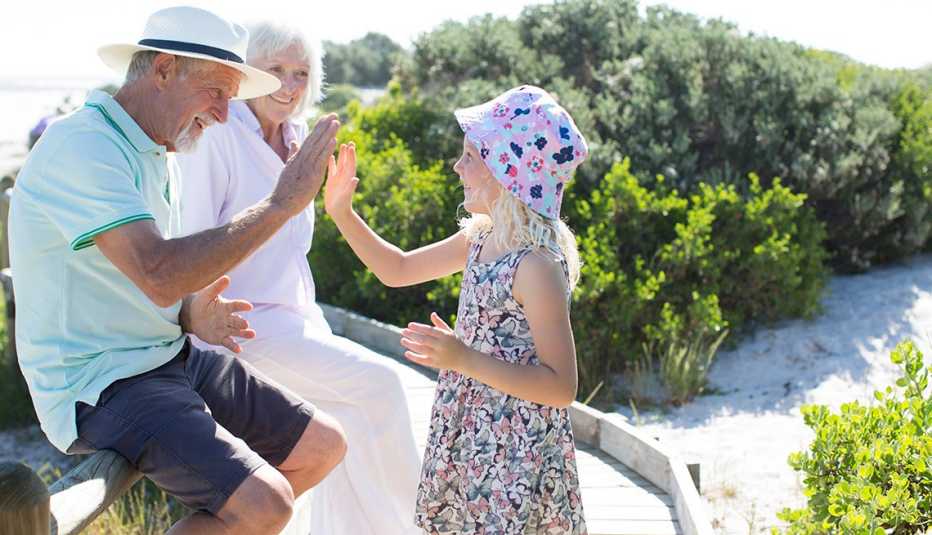 older man high fives a child
