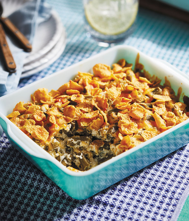 green been casserole with cornflakes on top in dish on table green been casserole with cornflakes on top in dish on table