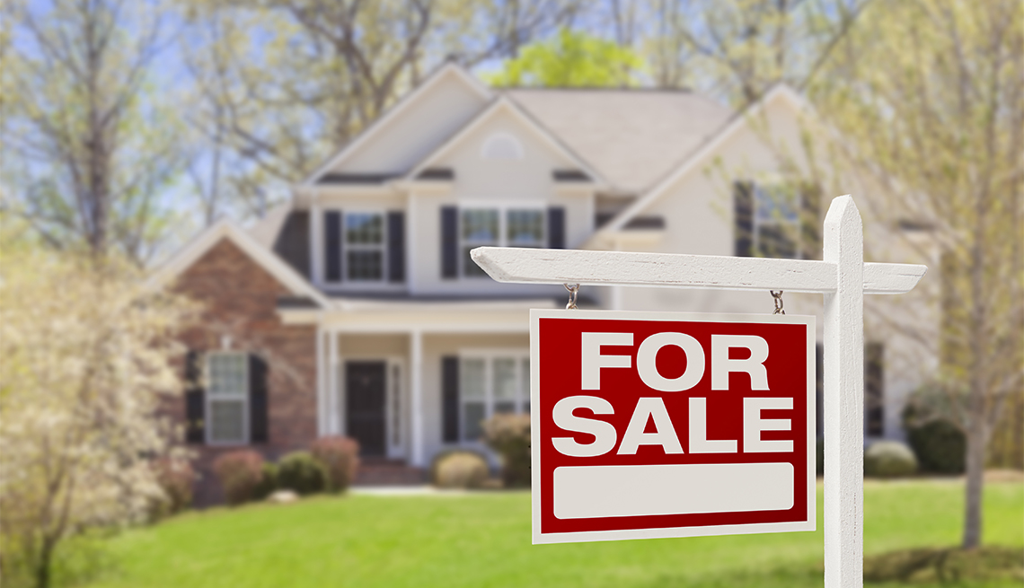 Home with for sale sign on the yard