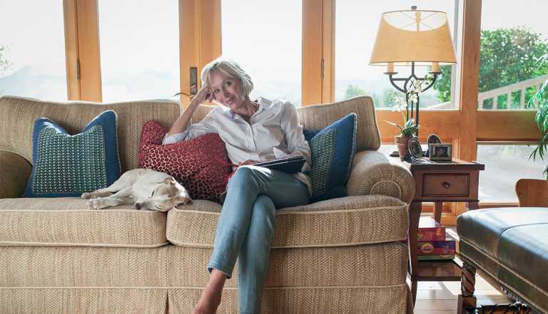 woman sitting on a couch with her dog