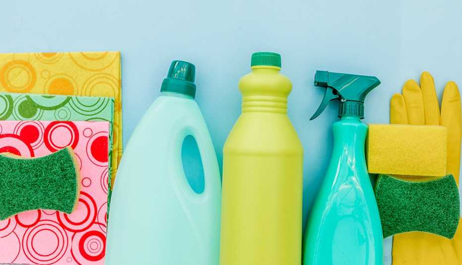 cleaning products and sponges and gloves on a blue background