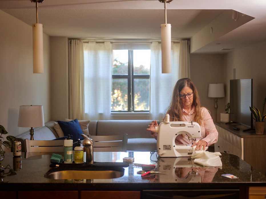 Gina Montimny sewing in her apartment
