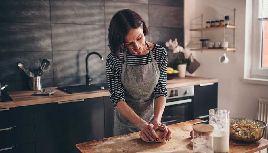 A woman kneading dough