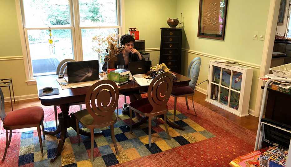 photo of a living and dining room area with a lot of clutter photo of a living and dining room area with a lot of clutter