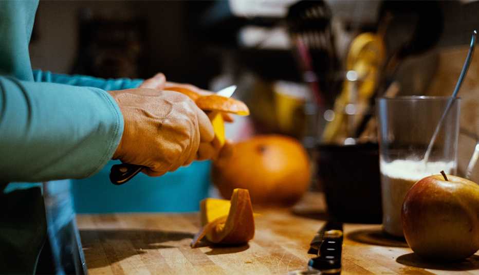 woman peeling a pumpkin
