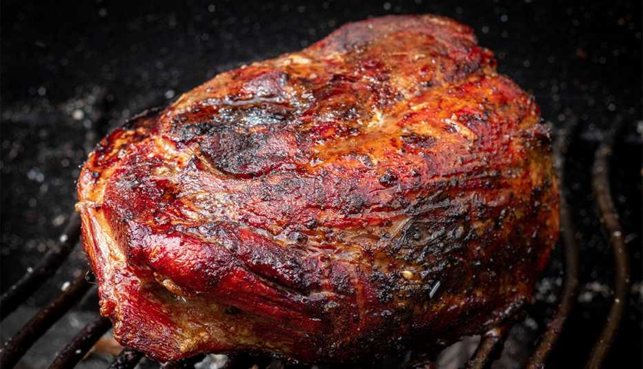 pork shoulder grilling on a smoker