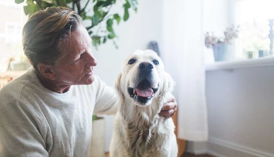 Man looks lovingly at his pet dog