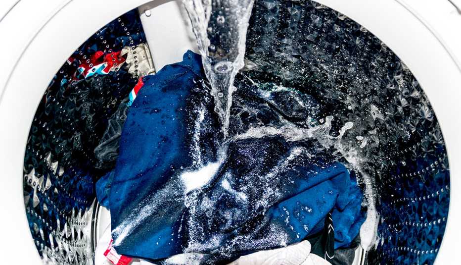 clothes in washer with water pouring down