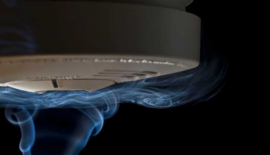 Smoke crawling over smoke detector.