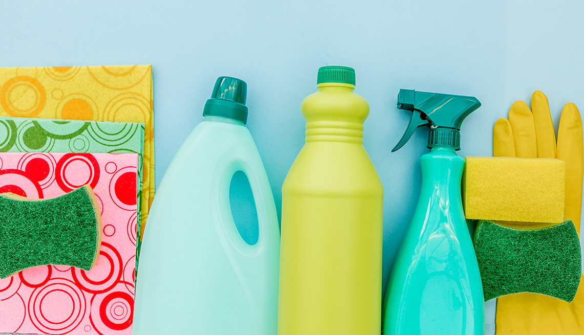 cleaning products and sponges and gloves on a blue background