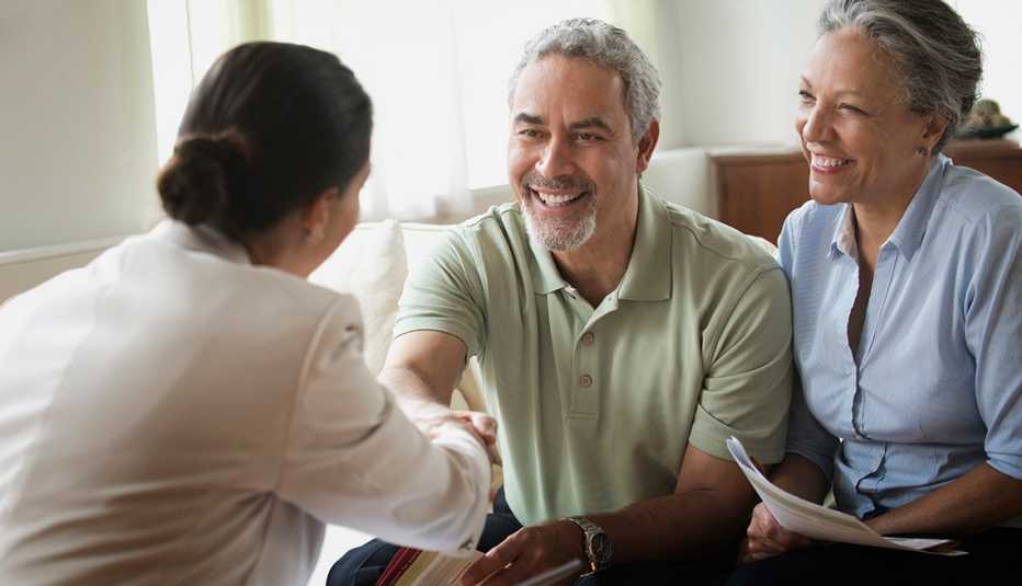 saleswoman talking to clients in living room