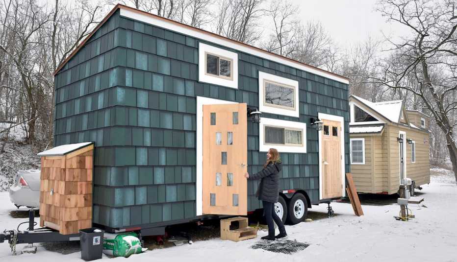 A tiny home is on wheels to be transported to a new location