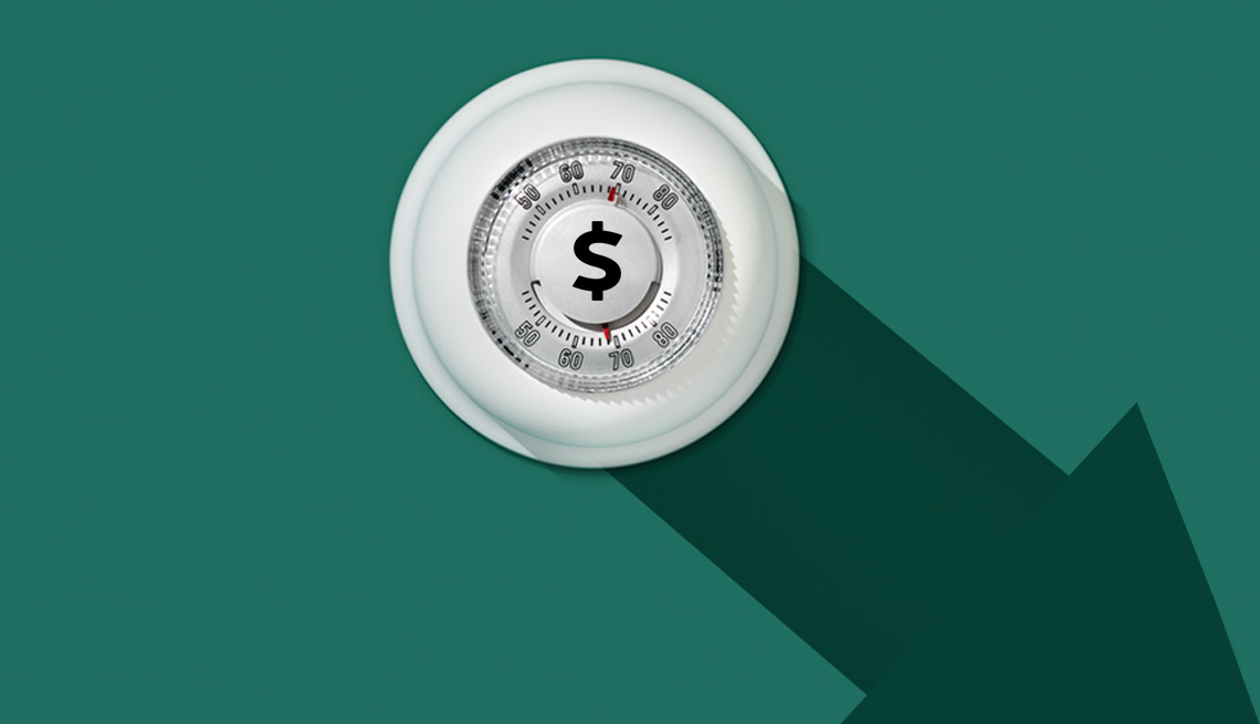 a programmable thermostat with an arrow pointing down on a green background