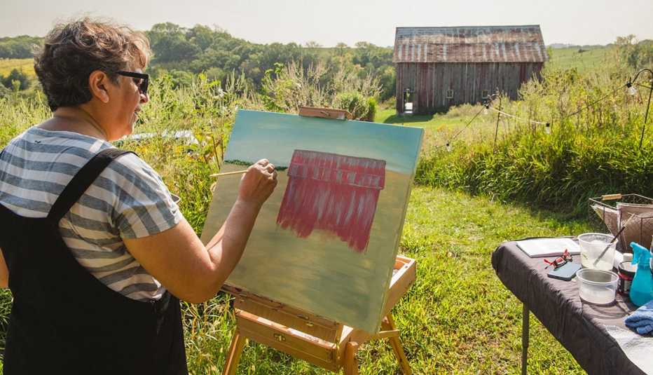 a person painting a barn