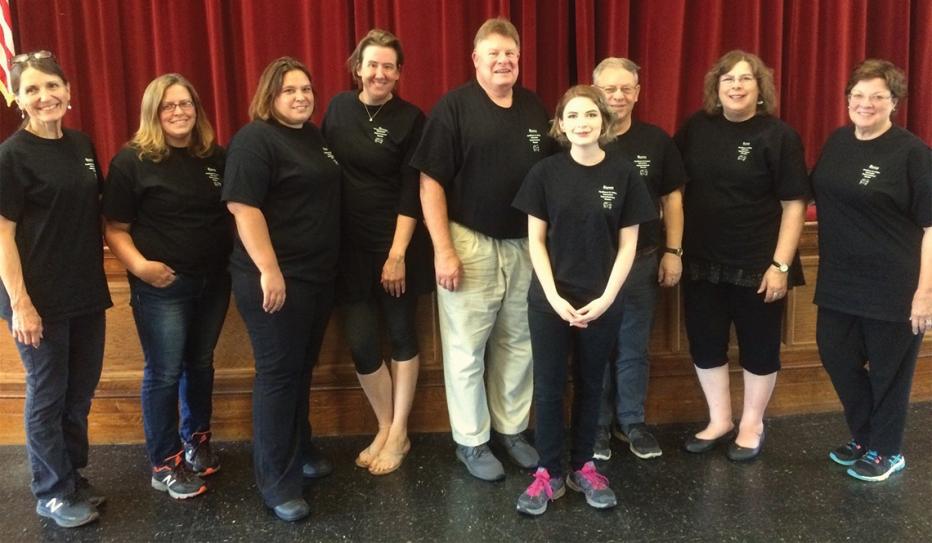 Nine members of the acting troupe pose for a group portrait