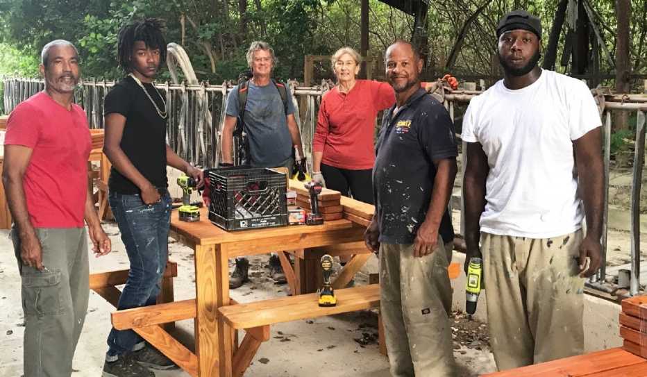 Six people building trail tables and benches