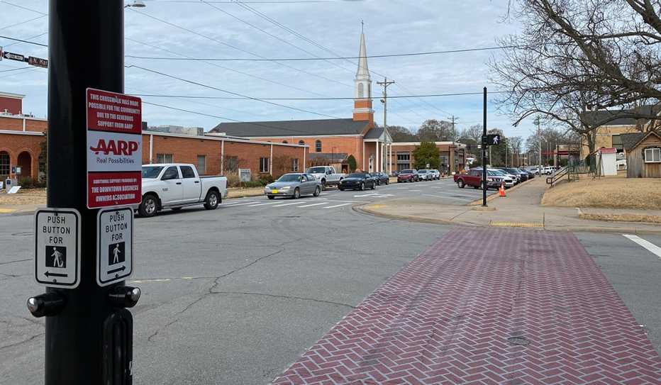 A brick crosswalk and signage thanking AARP for the funding to create it