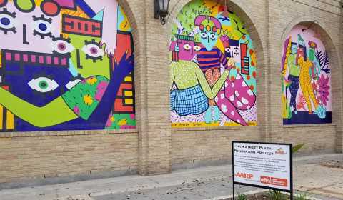 Three murals decorate a brick wall as part of the 14th Street Plaza Renovation Project