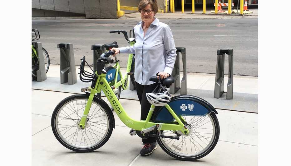Minneapolis resident Phyllis Rodan poses next to a Nice Ride bike-share bicycle