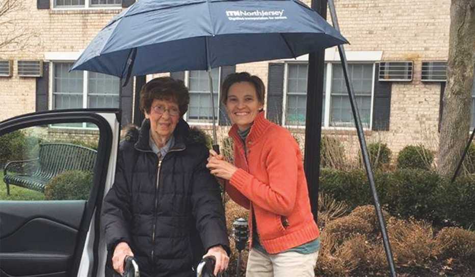 A volunteer driver from ITN Northern Jersey helps her client get to the car. A volunteer driver from ITN Northern Jersey helps her client get to the car.