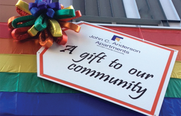 An oversized gift tag decorates the front of the John C. Anderson Apartments