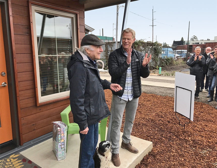 2 Men and a dog on the porch of a tiny home 2 Men and a dog on the porch of a tiny home